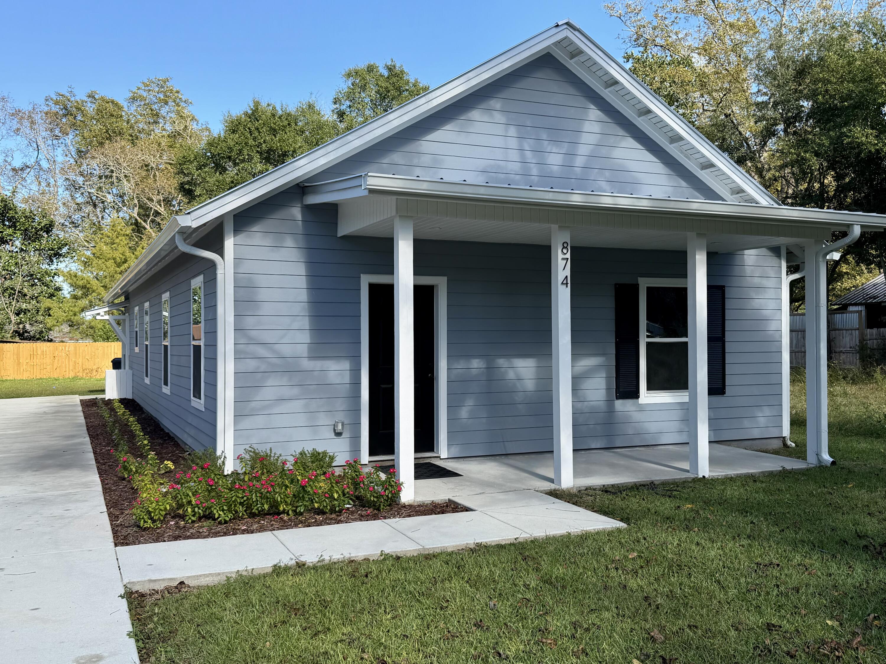 874 West Orange Avenue DeFuniak Springs, FL 32435 - Photo 1 of 32 a front view of a house with a yard