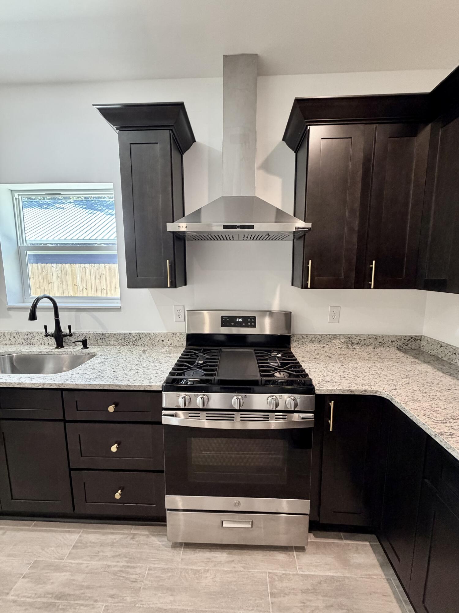 874 West Orange Avenue DeFuniak Springs, FL 32435 - Photo 11 of 32 a stove top oven sitting inside of a kitchen