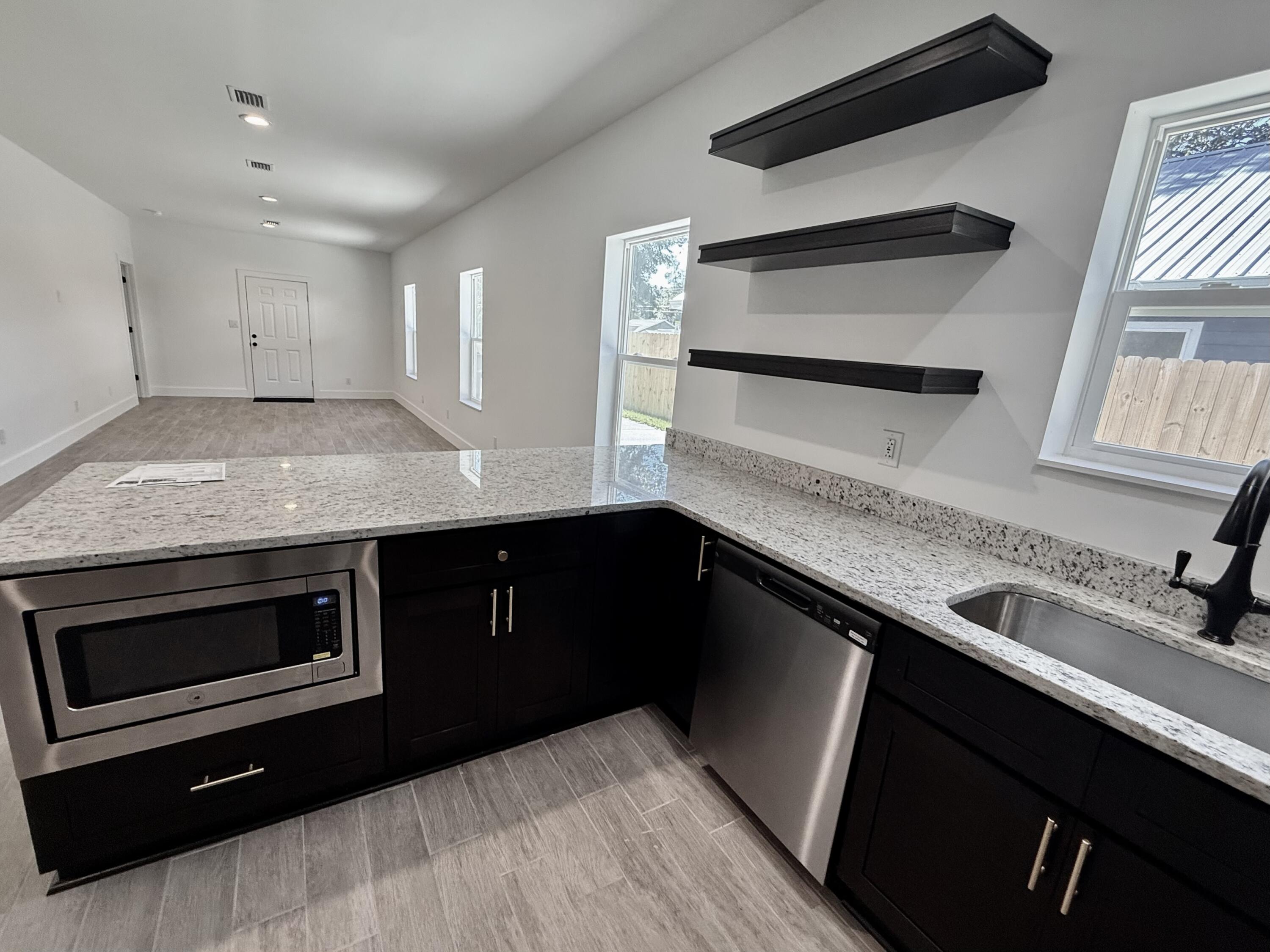874 West Orange Avenue DeFuniak Springs, FL 32435 - Photo 13 of 32 a kitchen with a sink and wooden floor