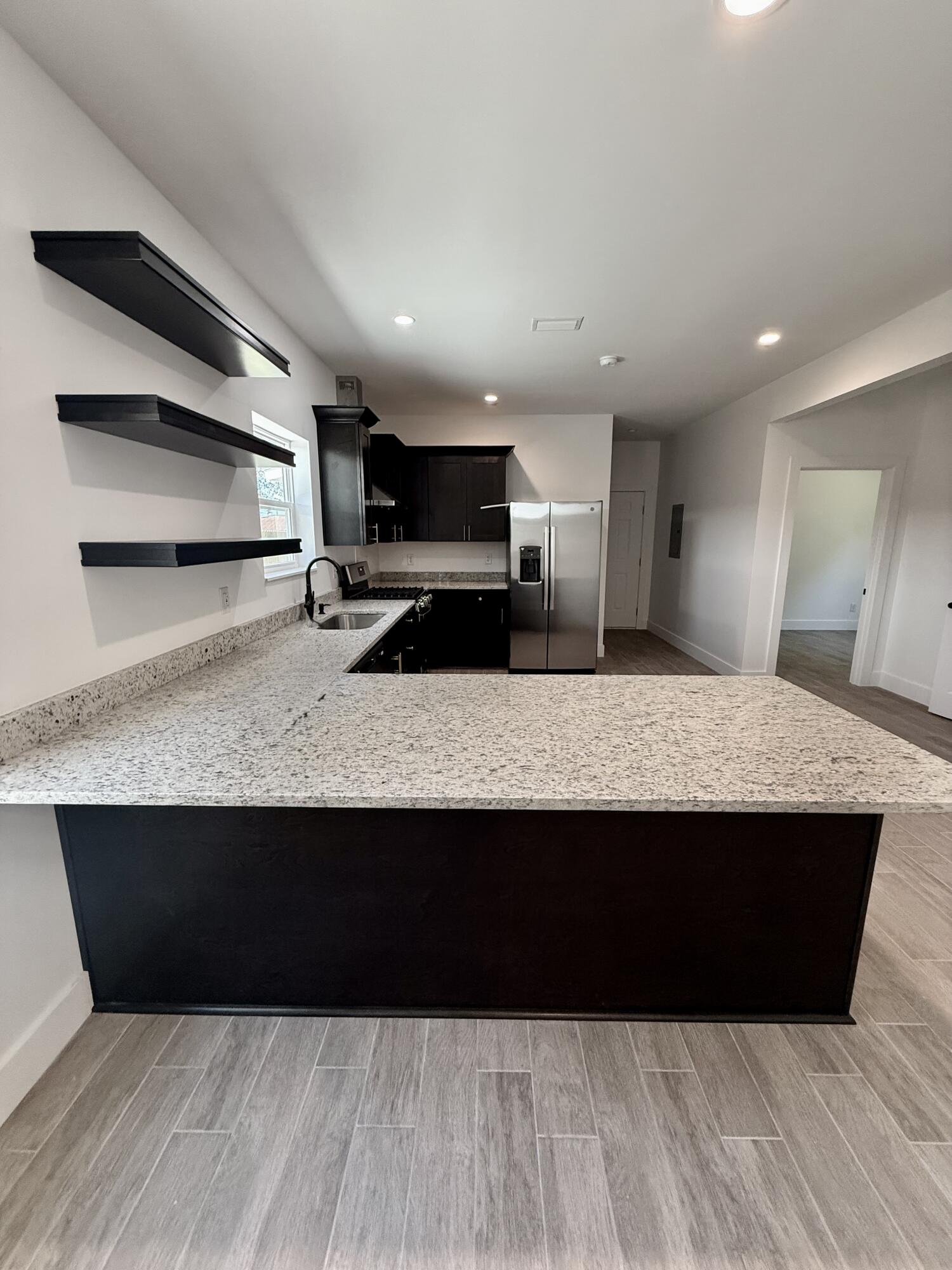 874 West Orange Avenue DeFuniak Springs, FL 32435 - Photo 14 of 32 a kitchen with stainless steel appliances a sink and a microwave