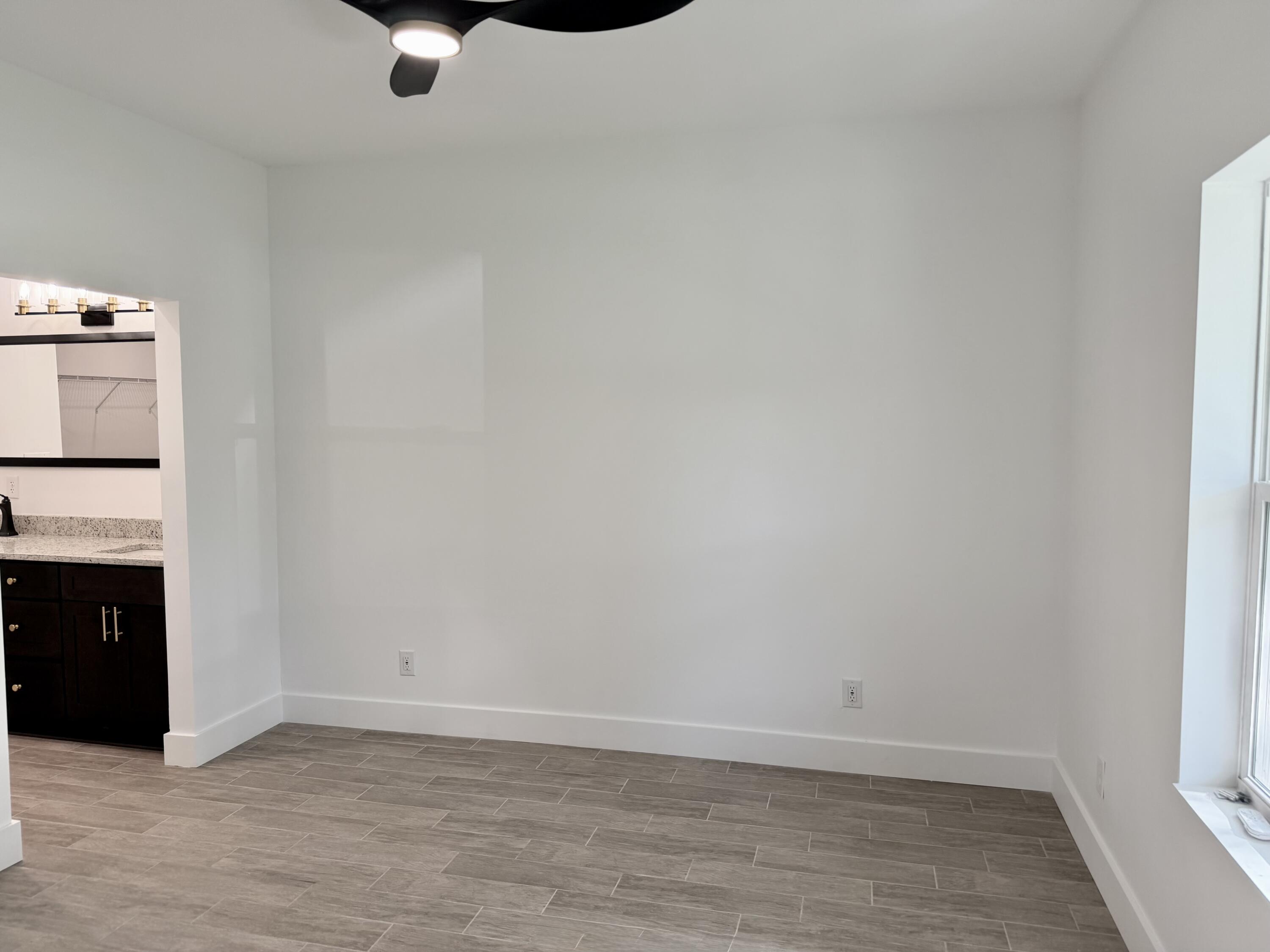 874 West Orange Avenue DeFuniak Springs, FL 32435 - Photo 16 of 32 a view of empty room with wooden floor
