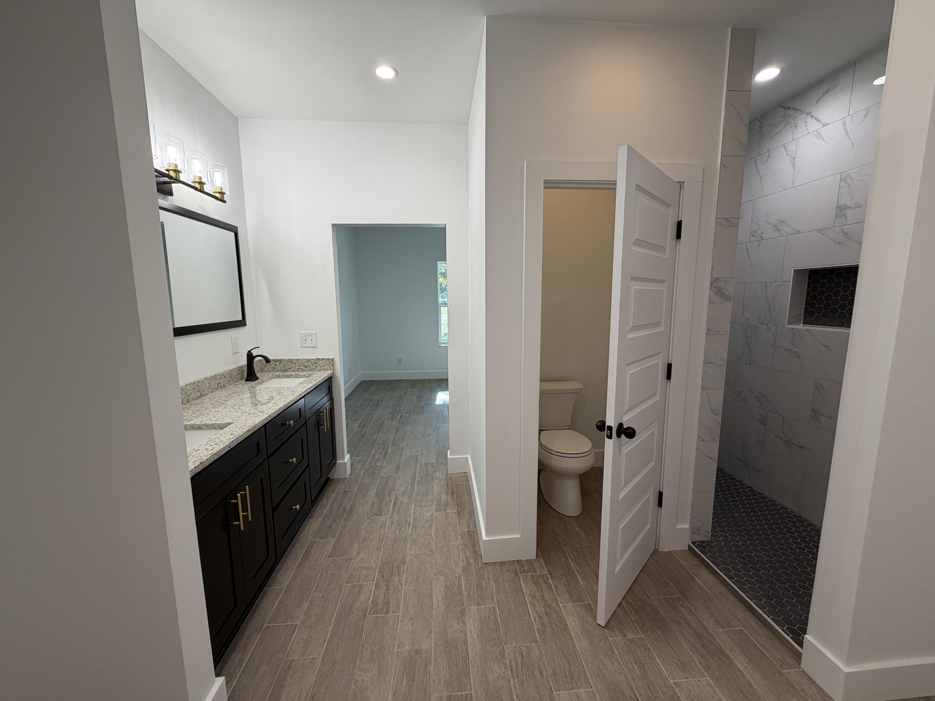 874 West Orange Avenue DeFuniak Springs, FL 32435 - Photo 18 of 32 a bathroom with a double vanity sink and mirror