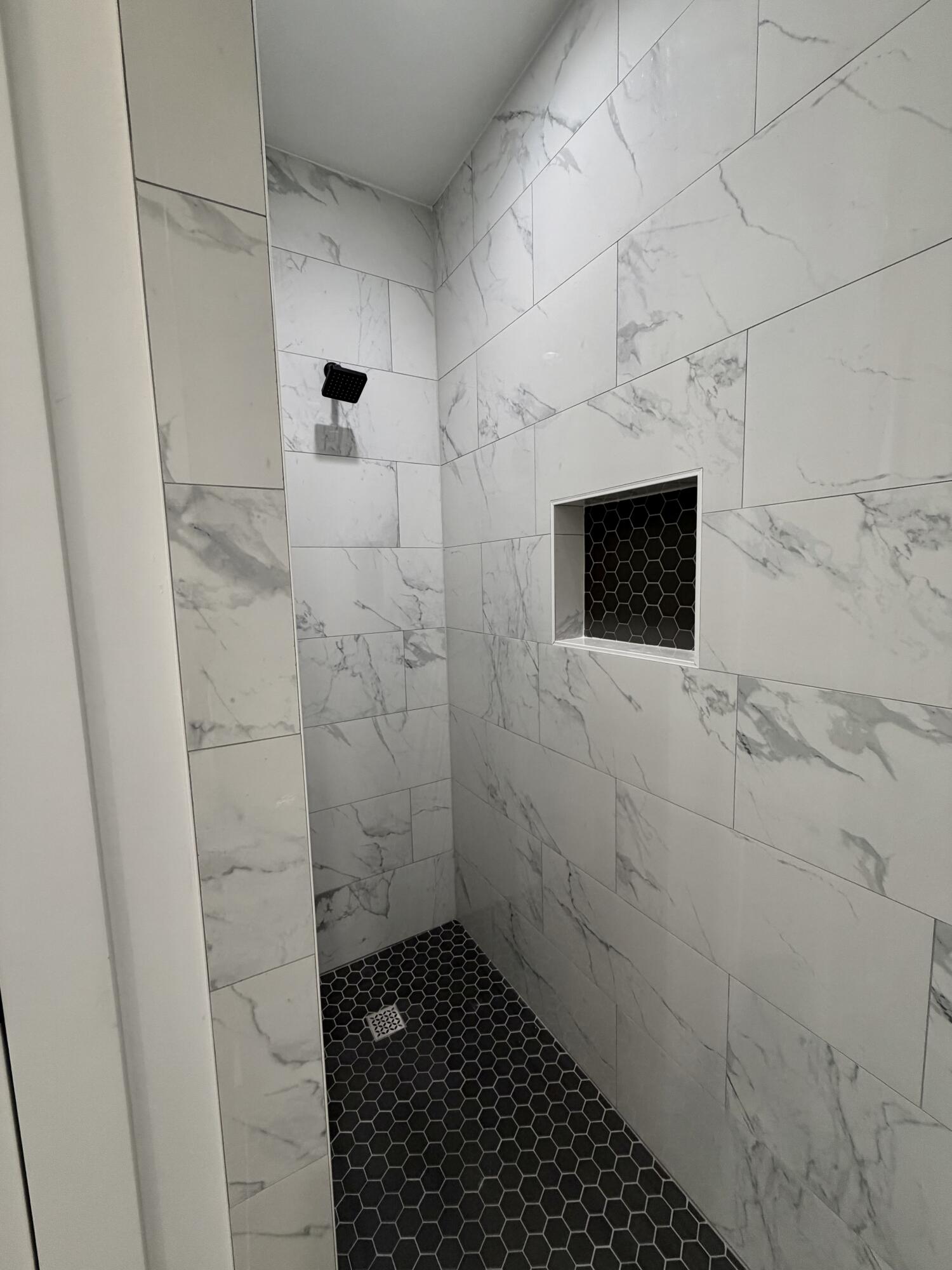 874 West Orange Avenue DeFuniak Springs, FL 32435 - Photo 20 of 32 a bathroom with a shower and a tiled wall