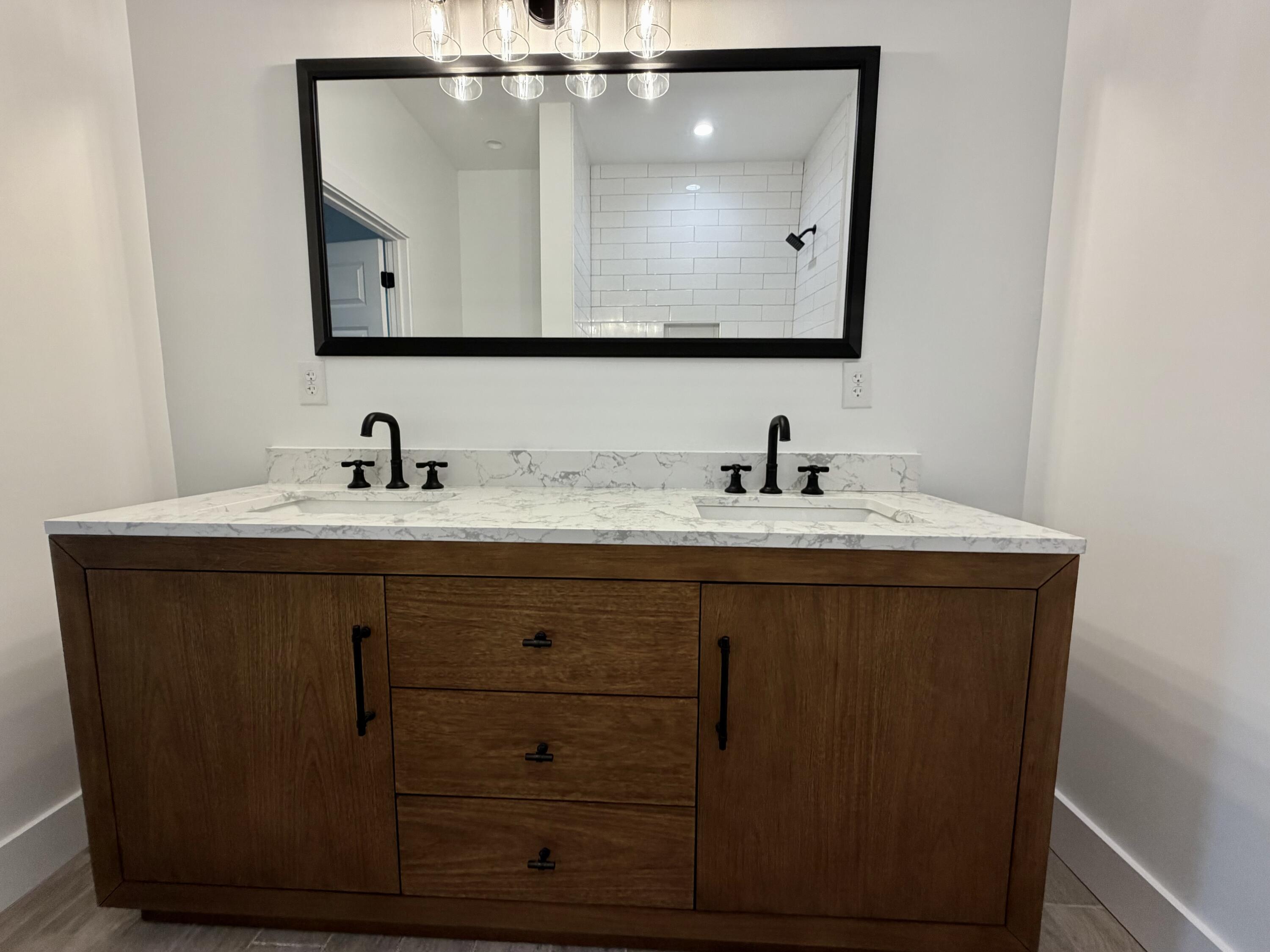 874 West Orange Avenue DeFuniak Springs, FL 32435 - Photo 26 of 32 a bathroom with a sink vanity and a mirror