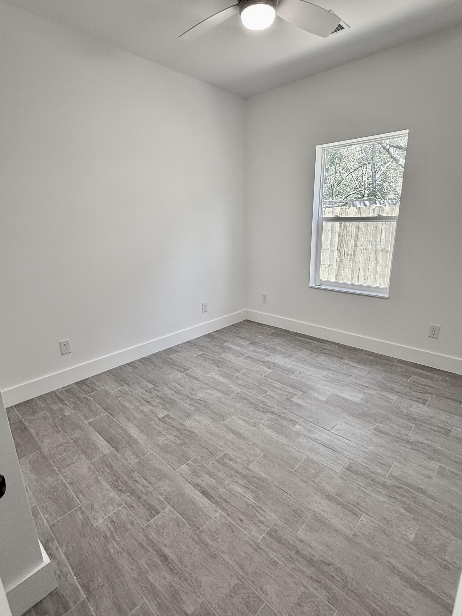 874 West Orange Avenue DeFuniak Springs, FL 32435 - Photo 29 of 32 an empty room with a window