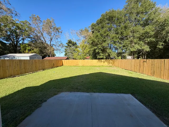 a kitchen with a sink and wooden floor