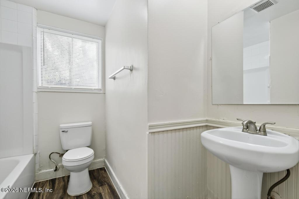 3024 Kline Road Jacksonville, FL 32246 - Photo 14 of 25 a bathroom with a toilet a sink and mirror