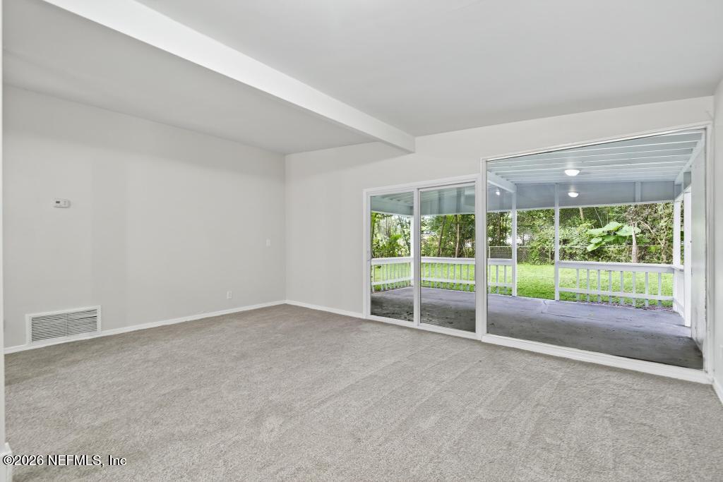 3024 Kline Road Jacksonville, FL 32246 - Photo 19 of 25 a view of an empty room with wooden floor and a fireplace