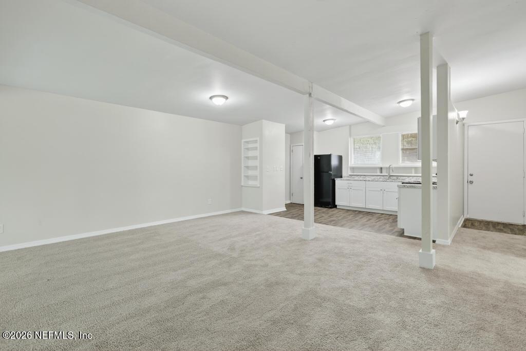 3024 Kline Road Jacksonville, FL 32246 - Photo 4 of 25 an empty room with a kitchen