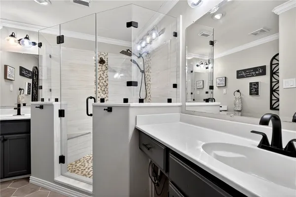 a bathroom with a sink double vanity and a shower