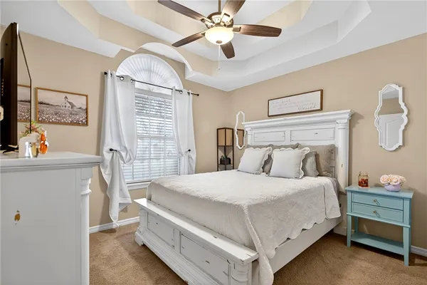 a bedroom with a bed and a chandelier
