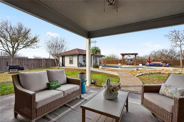 a roof deck with couches and potted plants