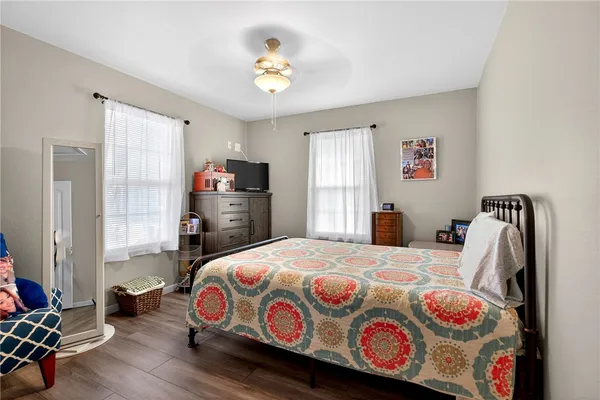 a bedroom with a bed and wooden floor