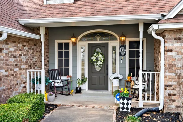 a front view of a house with outdoor seating