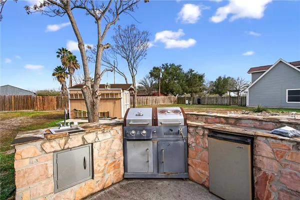 a view of a kitchen with a stove top oven