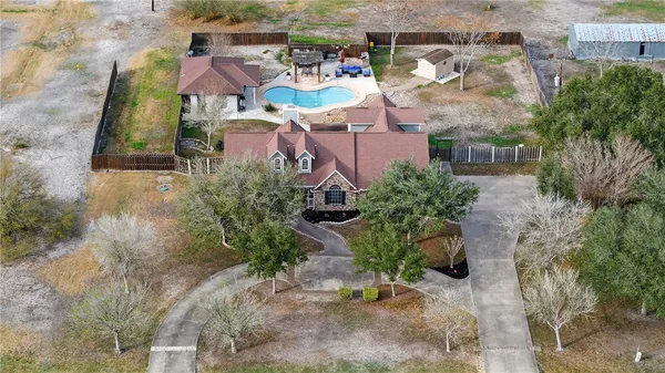 an aerial view of a house with a yard