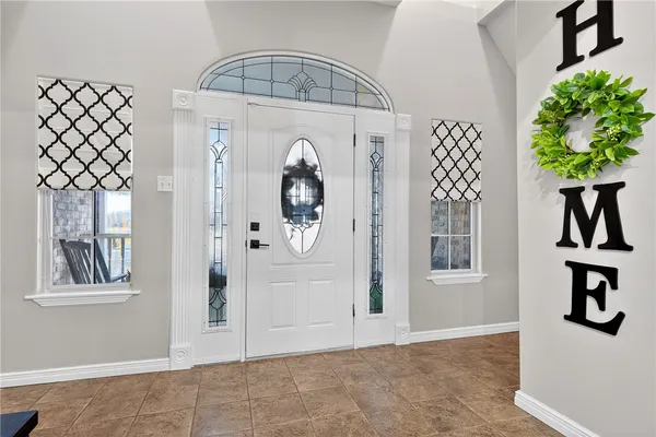 an entryway view with wooden floor and a chandelier