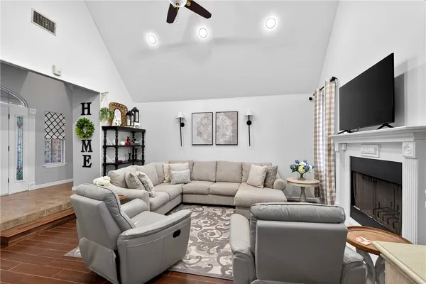 a living room with furniture fireplace and flat screen tv