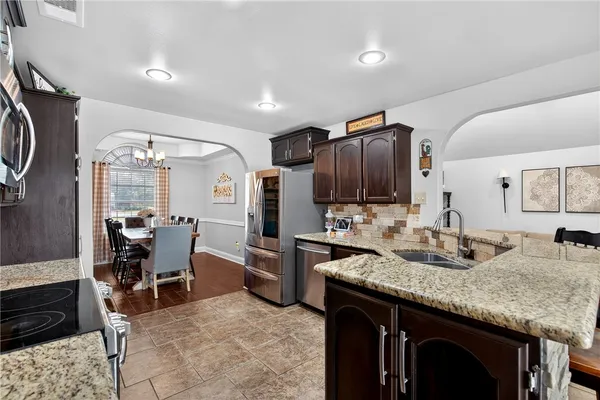 a kitchen with sink stove and cabinets