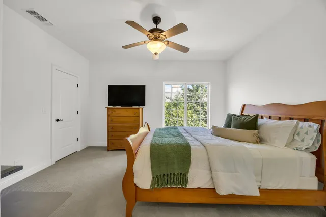 a bedroom with a bed and window