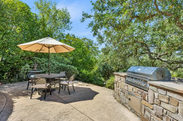 a view of a chairs and table under an umbrella