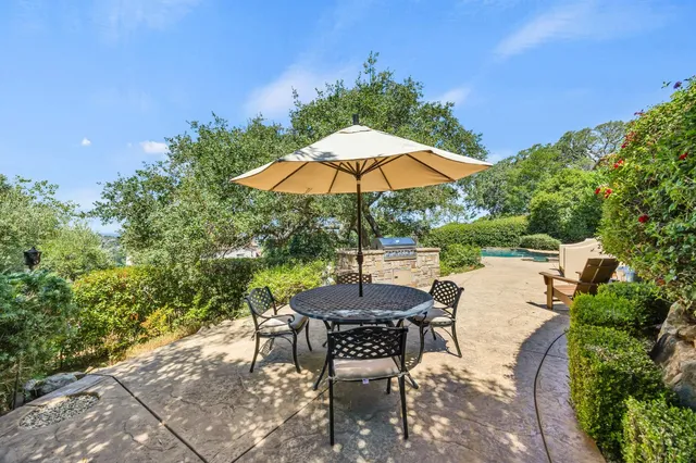 a view of backyard with seating space and trees