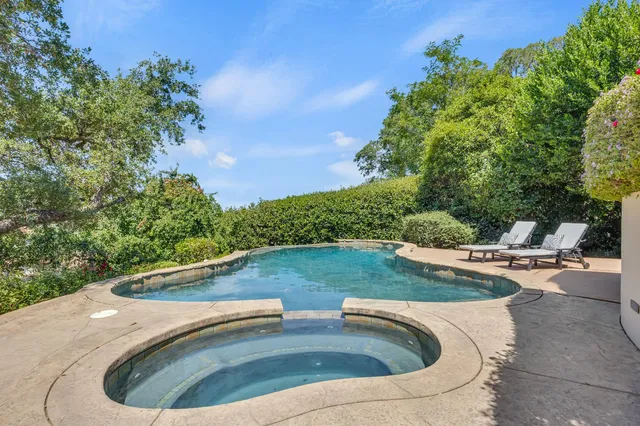 a view of a swimming pool with a yard