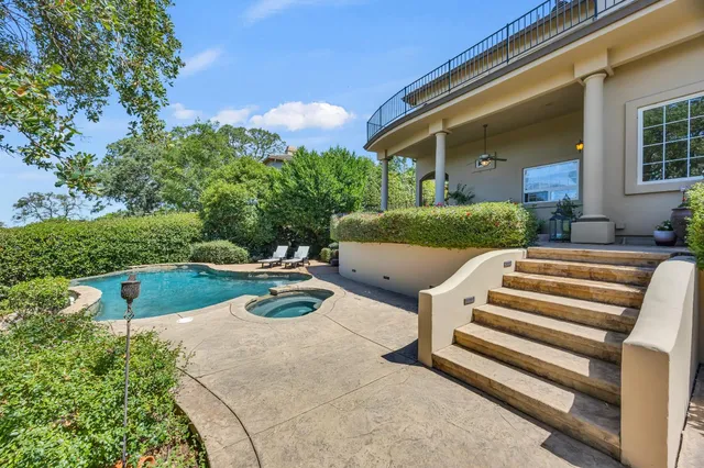 a view of a patio with swimming pool table and chairs