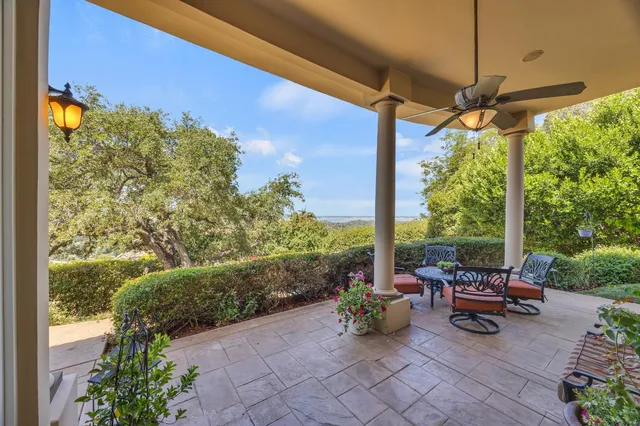 a view of a patio with table and chairs and potted plants