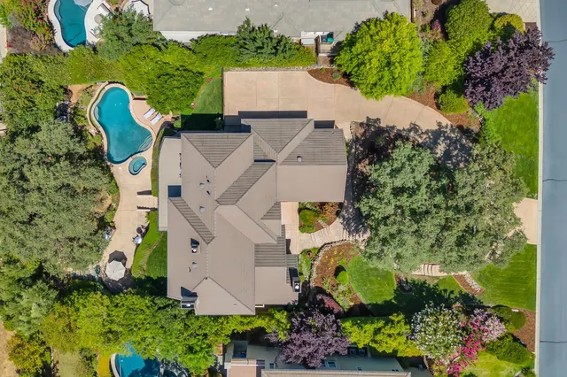 an aerial view of a house with a yard and garden