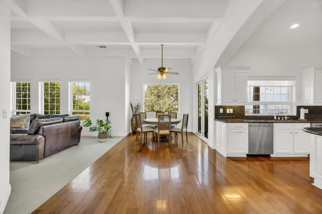 a living room with furniture dining table and wooden floors