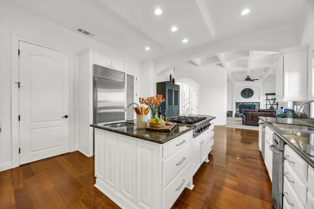 a kitchen with stainless steel appliances granite countertop a stove and a sink