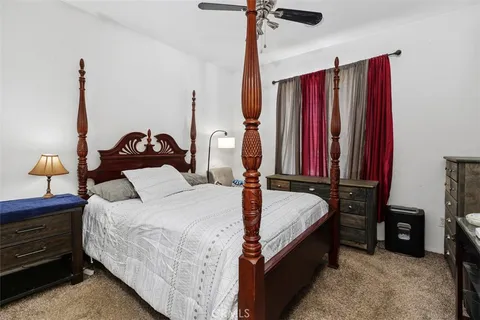 a bed room with a bed and a chair
