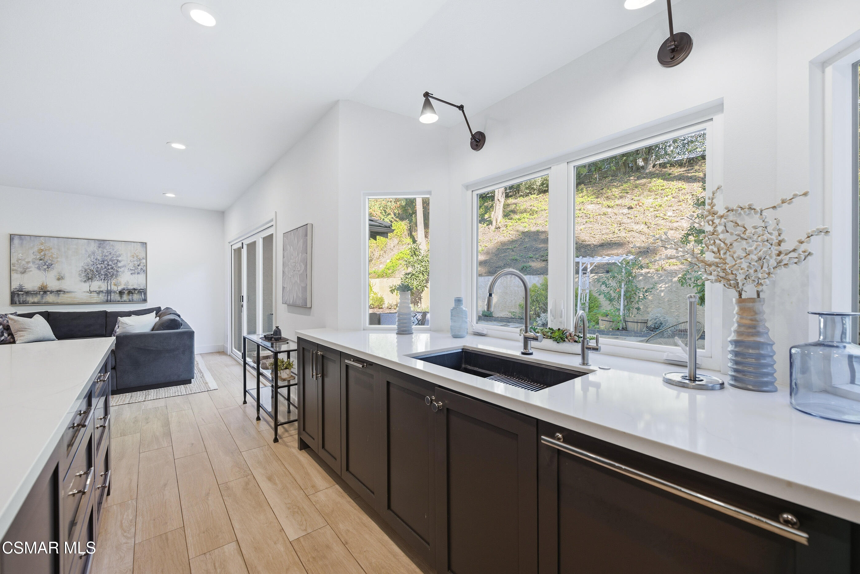 2810 Rikkard Drive Thousand Oaks, CA 91362 - Photo 12 of 38 a view of a kitchen with kitchen island a large window a sink and counter space