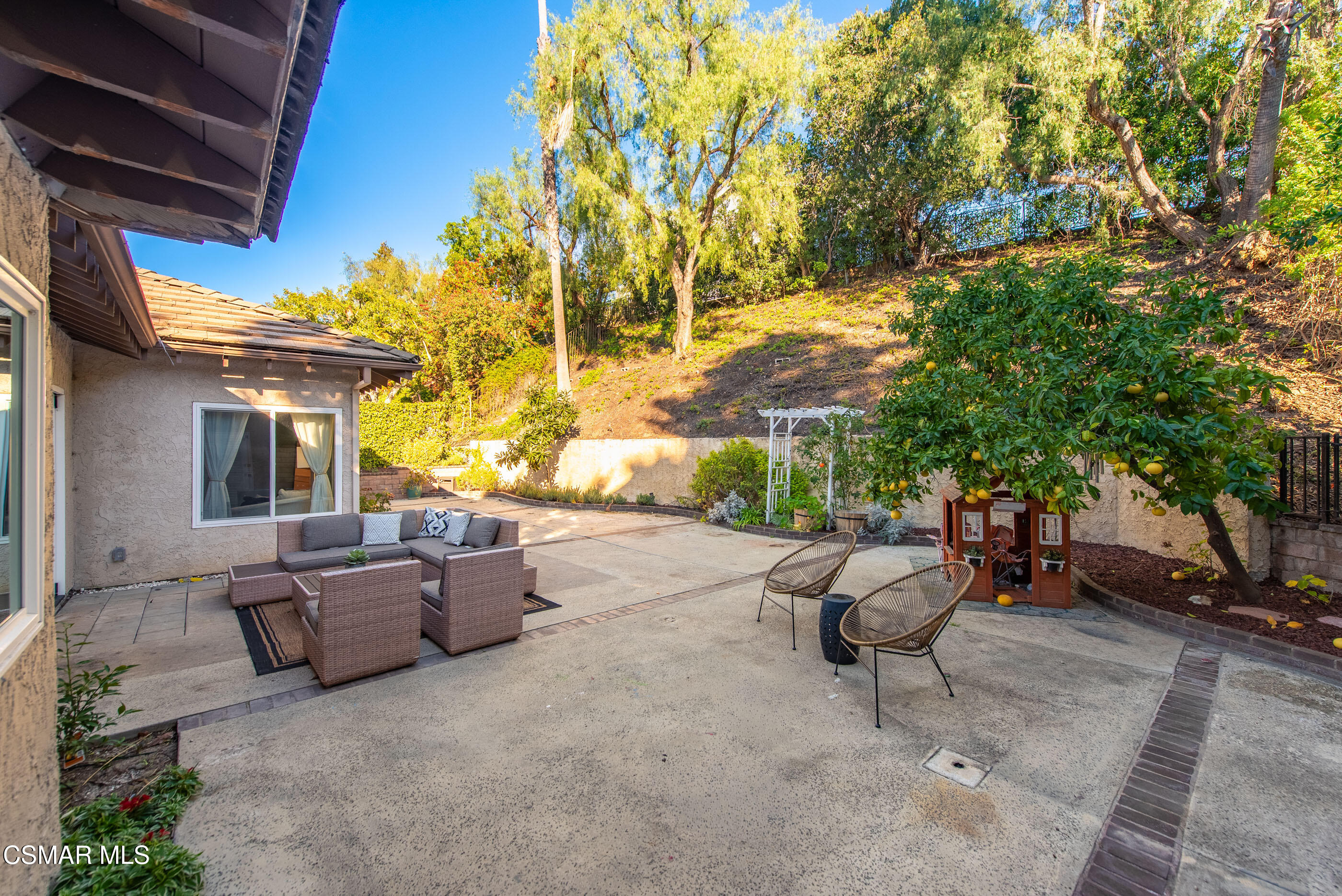 2810 Rikkard Drive Thousand Oaks, CA 91362 - Photo 32 of 38 a backyard of a house with table and chairs