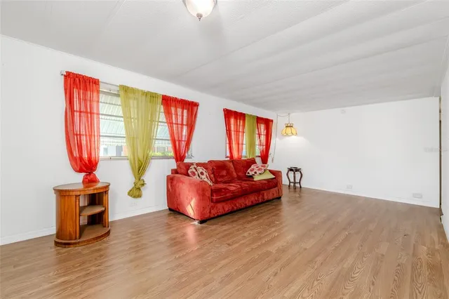 a living room with furniture windows and wooden floor