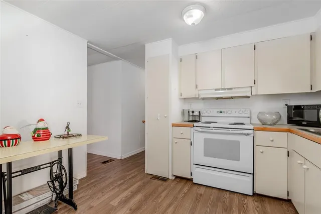 a kitchen with a white cabinets and white appliances