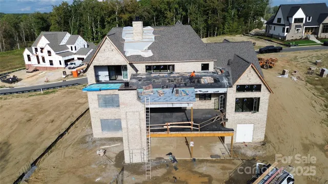 an aerial view of a house with yard and parking