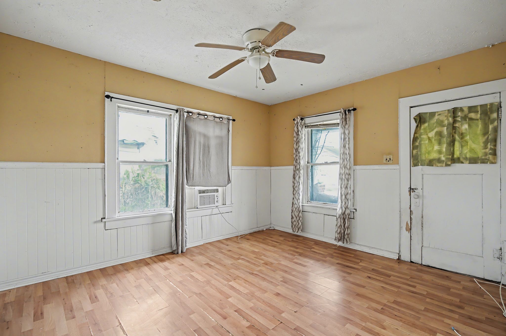 1222 Genova Street Houston, TX 77009 - Photo 8 of 15 a bedroom with a bed and wooden floor