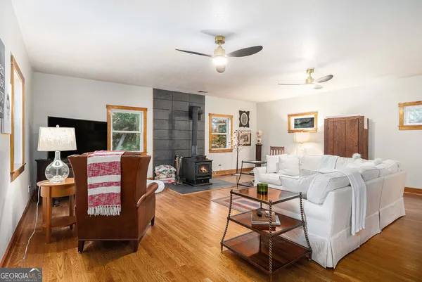 a living room with furniture and wooden floor