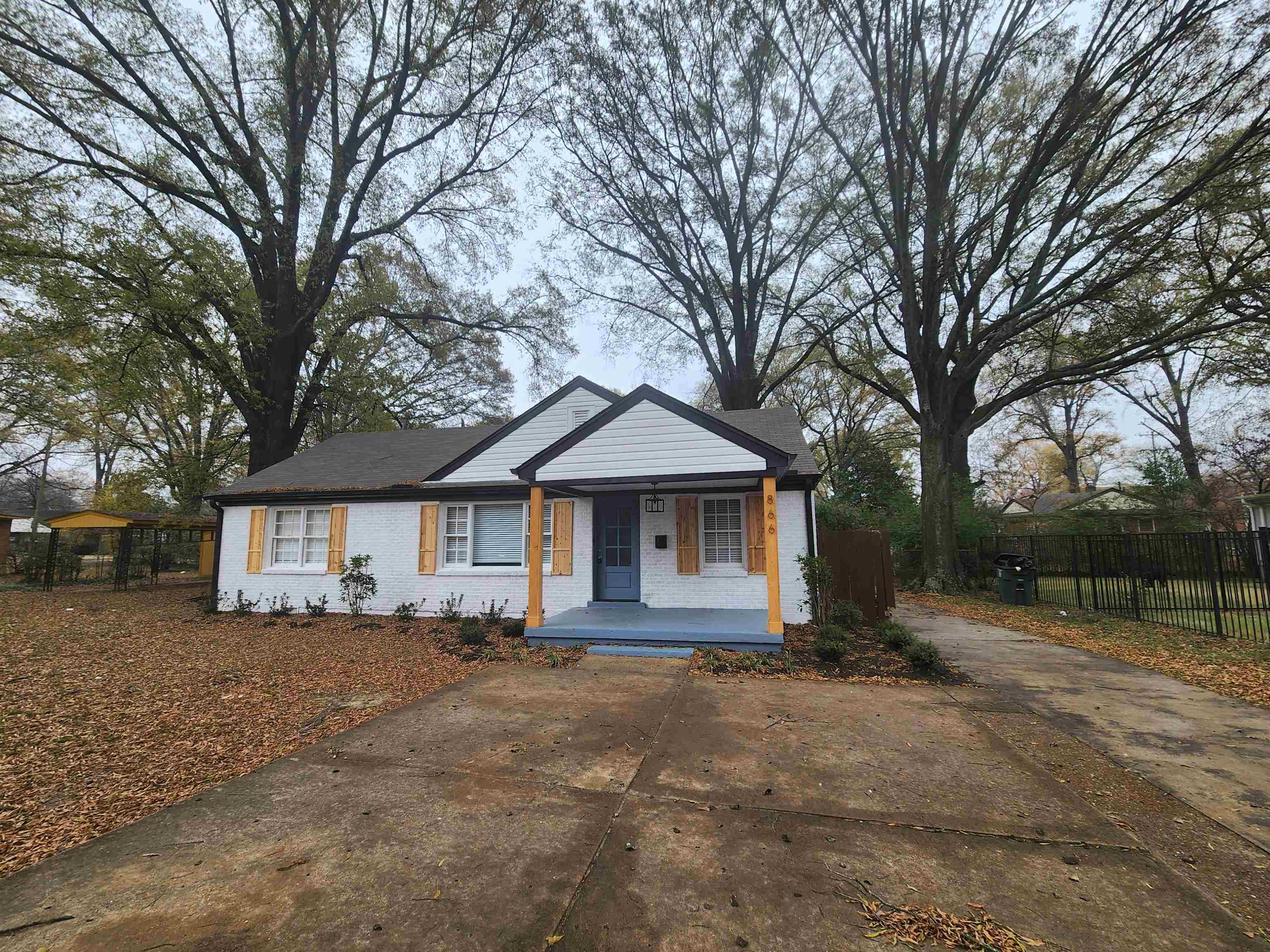866 Colonial Road Memphis, TN 38117 - Photo 2 of 15 a front view of a house with a yard and garage