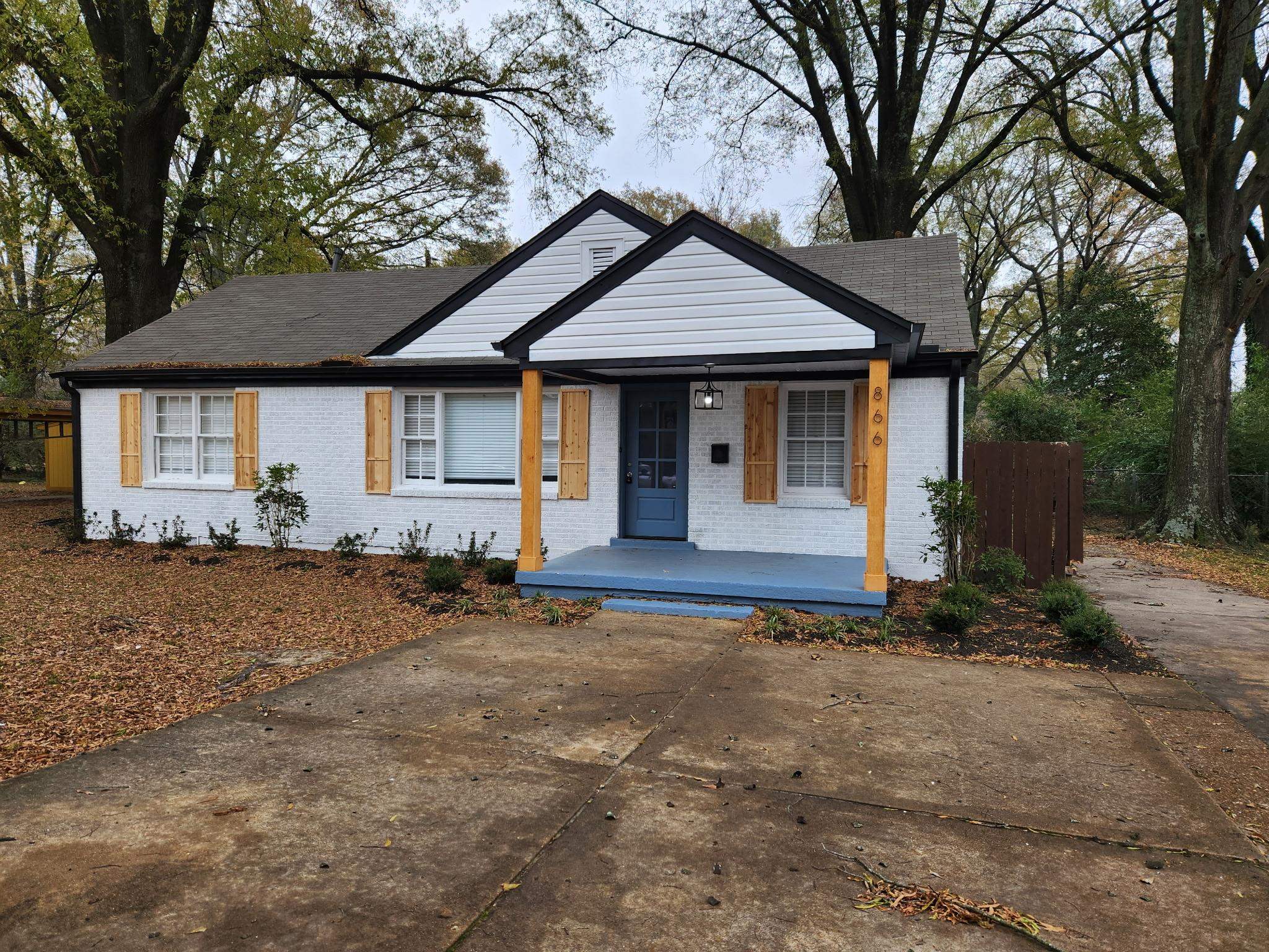866 Colonial Road Memphis, TN 38117 - Photo 3 of 15 a front view of a house with a yard and garage