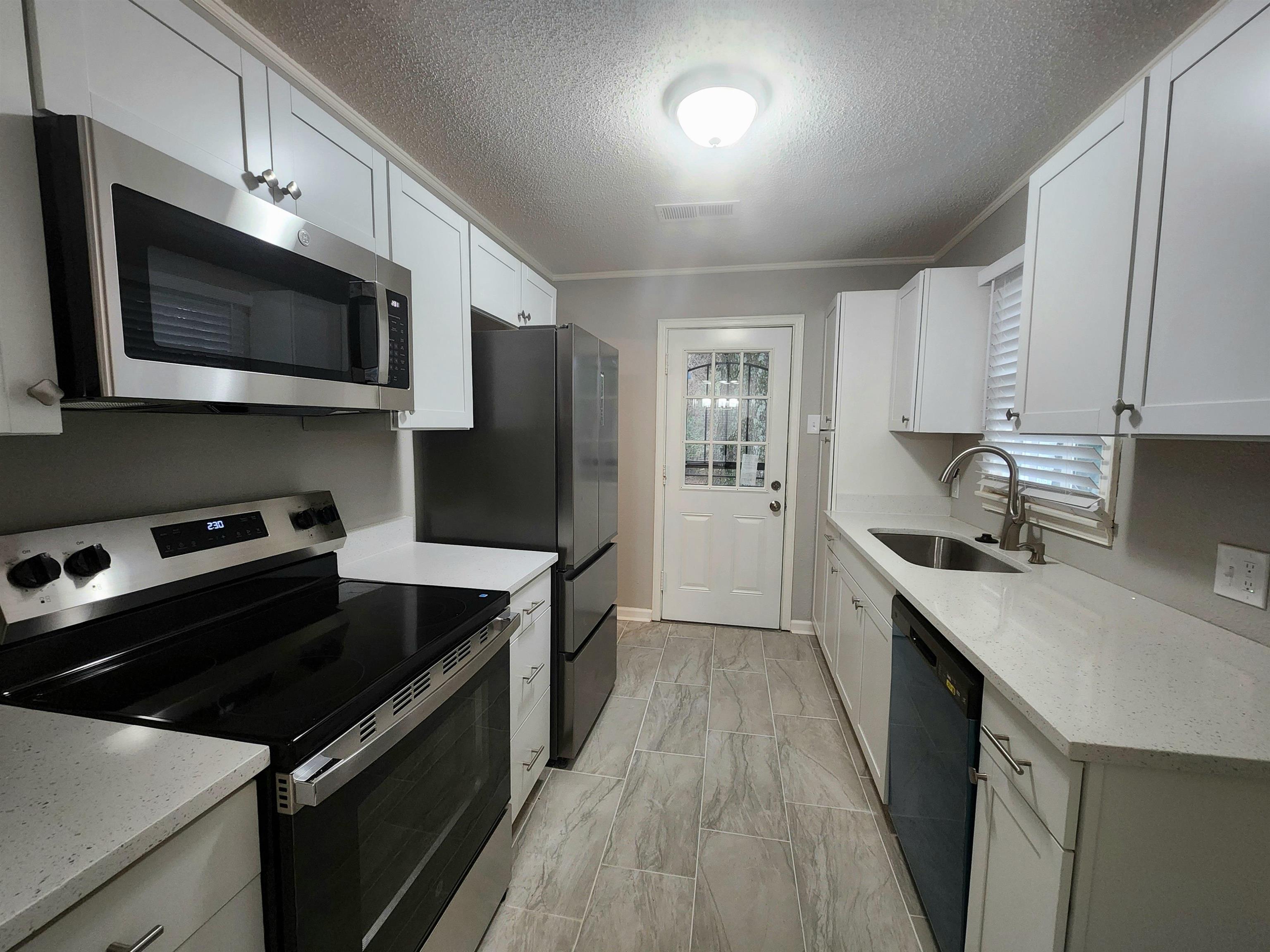 866 Colonial Road Memphis, TN 38117 - Photo 8 of 15 a kitchen with stainless steel appliances a sink dishwasher a stove and a microwave