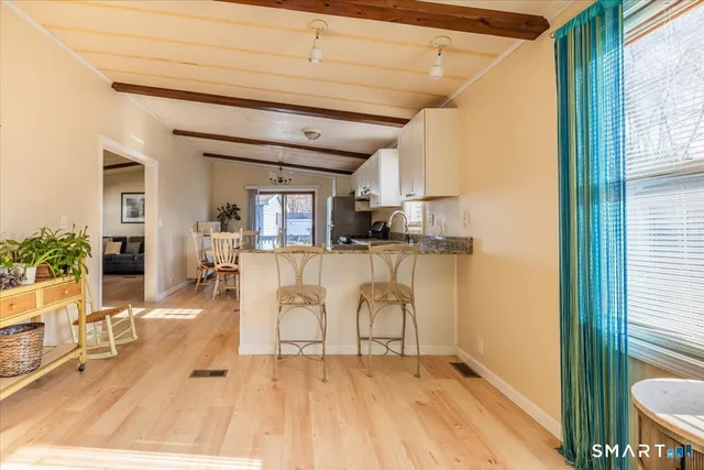 a view of a kitchen with furniture and wooden floor