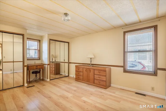 a view of a kitchen with a sink cabinet a fireplace and windows