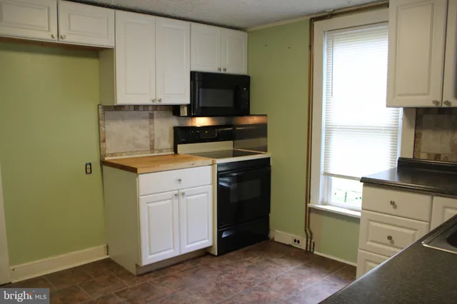 a kitchen with a sink and a stove top oven