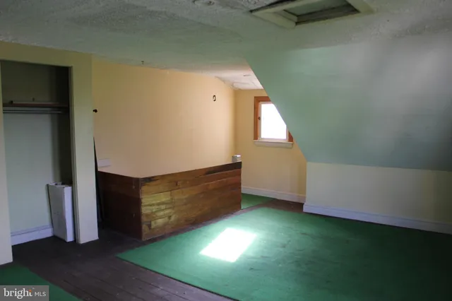 a view of room with window and wooden floor