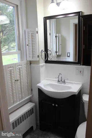 a bathroom with a sink a mirror and a window