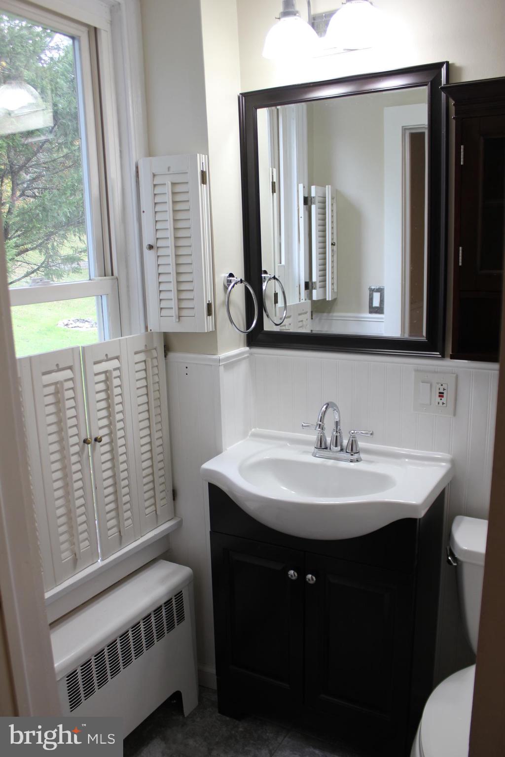 72 Sproul Road Malvern, PA 19355 - Photo 9 of 31 a bathroom with a sink a mirror and a window