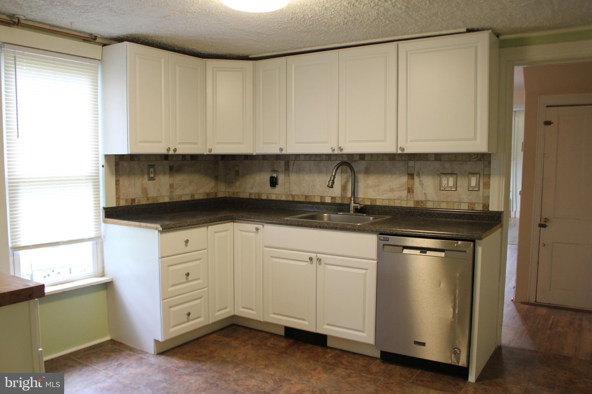 72 Sproul Road Malvern, PA 19355 - Photo 10 of 31 a kitchen with granite countertop white cabinets and stainless steel appliances